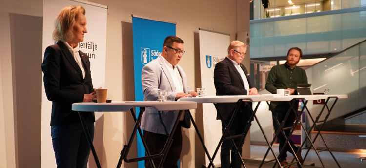 Politiker står på podium och pratar.